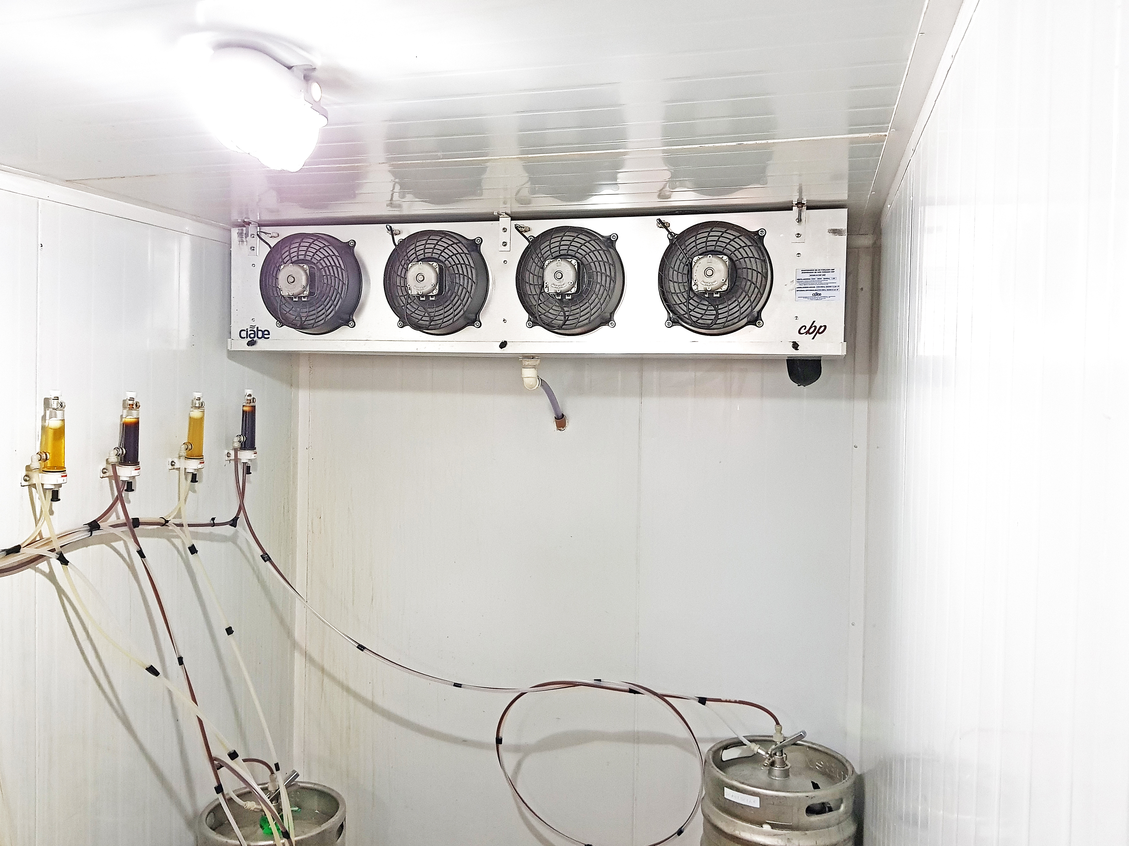 Interior de uma câmara fria em funcionamento com chopp estocado
